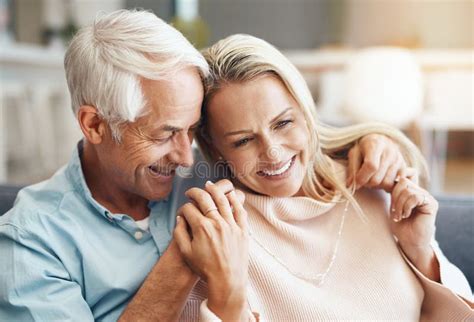 Smile Mature Couple And Hug On Sofa For Relax Together Bonding And Partner Support In Home
