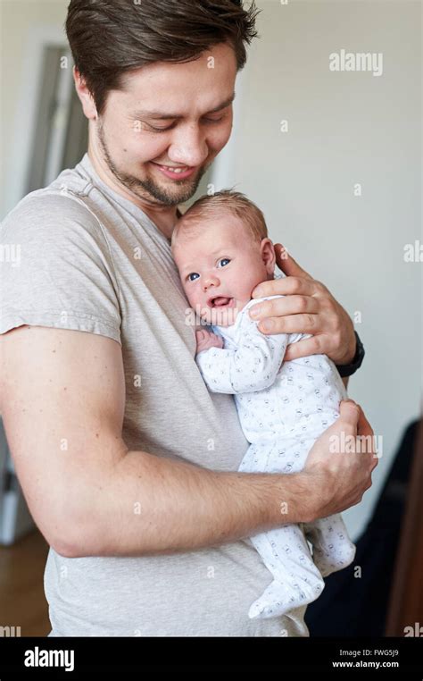 Happy Father Holding Newborn Baby In His Arms Stock Photo Alamy