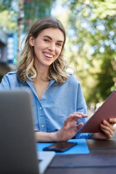 Vertical Shot Of Smiling Successful Businesswoman Using Digital Tablet