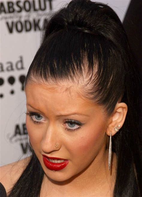 Christina Aguilera's long black hair styled into a high and tight ponytail