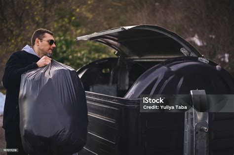 Man Puts Recycle Trash In Bin Stock Photo Download Image Now