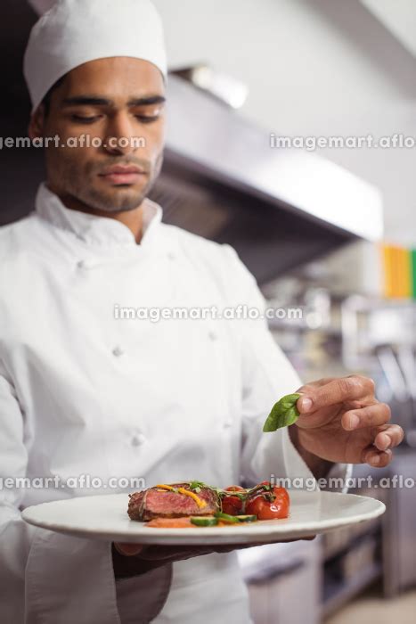 Chef Holding Delicious Dish In Kitchen