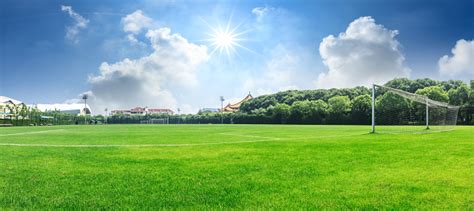 Green Football Field Under Blue Sky Stock Photo - Download Image Now ...