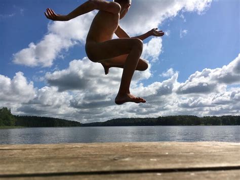 Premium Photo Naked Man Jumping At Lake Against Sky