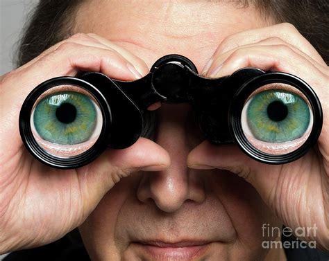 Man Holding Binoculars With Eyes On Lenses Photograph by Victor De ...