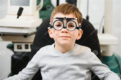 Cheerful Child Boy In Glasses Checks Eye Vision Pediatric