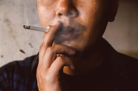 Premium Photo Close Up Of Man Smoking Cigarette