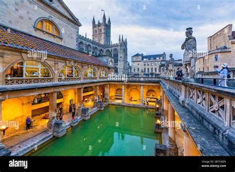 The Roman Baths And Bath Abbey Illuminated At Dusk Unesco World Heritage Site Bath Somerset