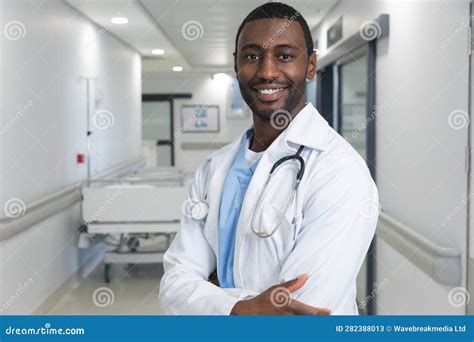 Portrait Of Happy African American Male Doctor Wearing Lab Coat And