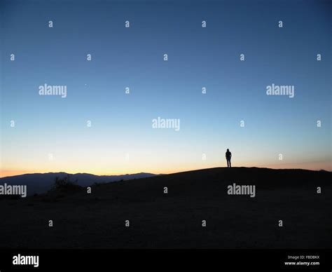 Silhouette Of Person Standing On Hill Stock Photo Alamy