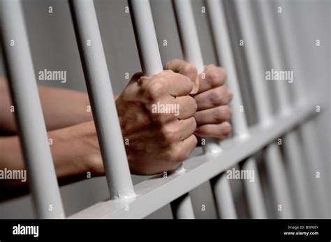 Hands Holding Prison Bars