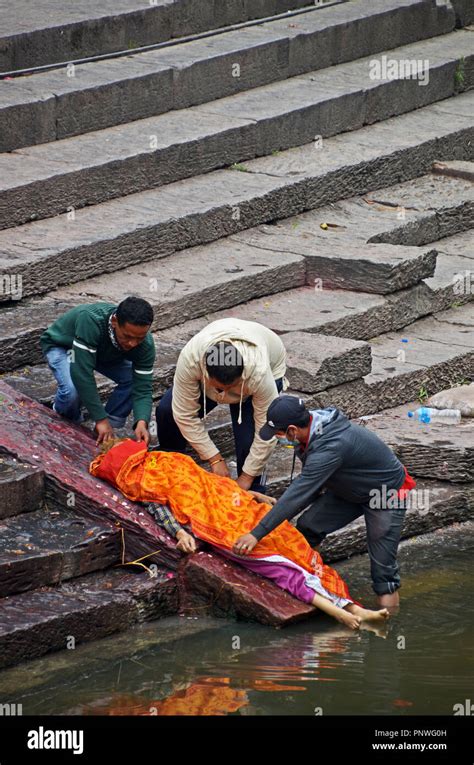 A Corpse Is Preopared For Cremation Beside The Bagmati River Near The