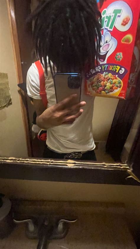 A Man With Dreadlocks Taking A Selfie In Front Of A Bathroom Mirror