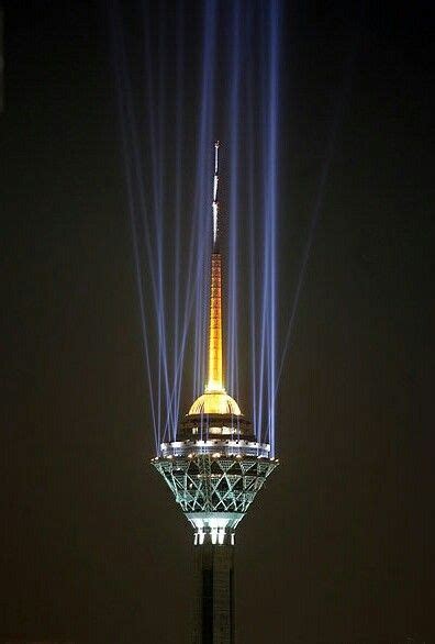 The Tower Is Lit Up With Blue And Yellow Lights