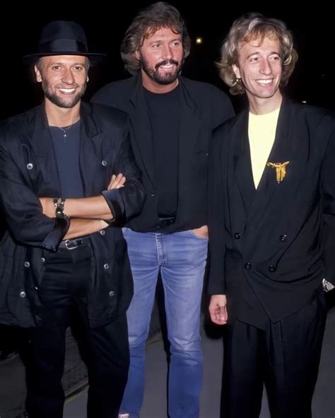 Three Men Standing Next To Each Other Smiling