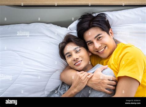 Happy Asian Homosexual Gay Men Male Couple Lying And Embracing On Bed LGBT And Sexual Diversity