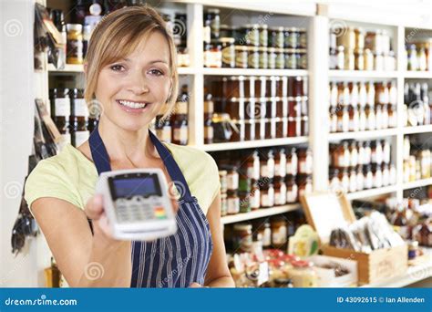 Sales Assistant In Food Store With Credit Card Machine Stock Image