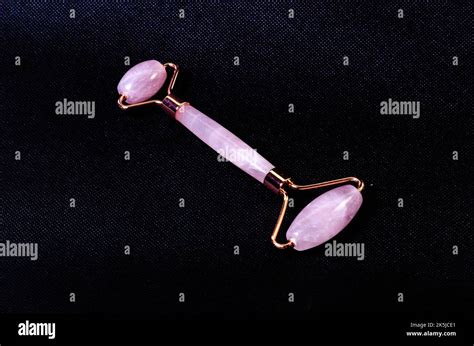 Rose Quartz Facial Roller And Massage Stone Gua Sha Isolated On White