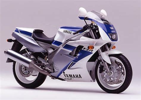 a blue and white yamaha motorcycle parked on a gray background with the ...