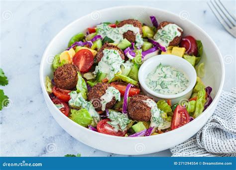 Falafel Salad With Avocado Tomato And Tahini Dressing Stock Photo