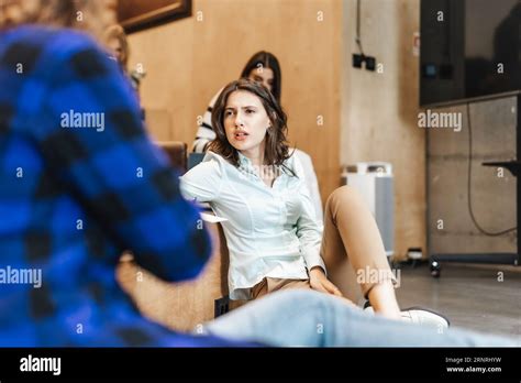 Beautiful Brunette Girl Trying To Figure It Out What Her Male Colleague Is Talking About Stock