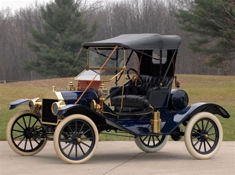 An Old Model T Car Parked In Front Of Some Trees