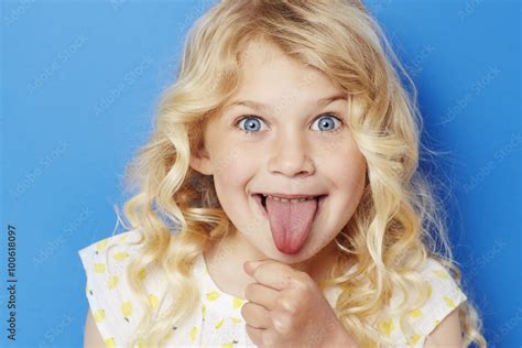 Young kid sticking out tongue portrait 스톡 사진 Adobe Stock