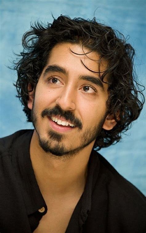 Smiling Man With Curly Hair And Beard