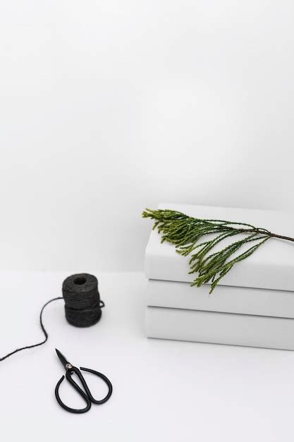 Free Photo Black Spool And Scissor With Stacked Of Book Stacked With