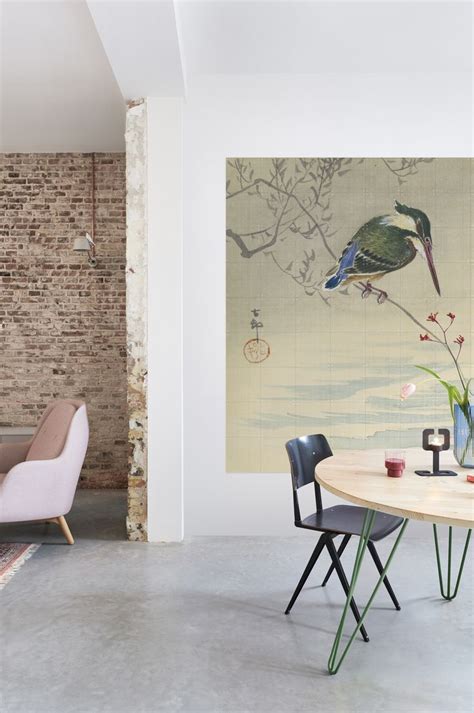 A Dining Room Table With Chairs And A Painting On The Wall