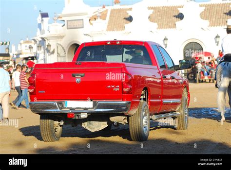 A rear view of a red pickup truck transport the pilgrimage, in the village el Rocio, Andalusia ...