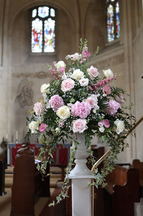 Traditional Pedestal Arrangement In Shades Of Pink In A White Urn Vase