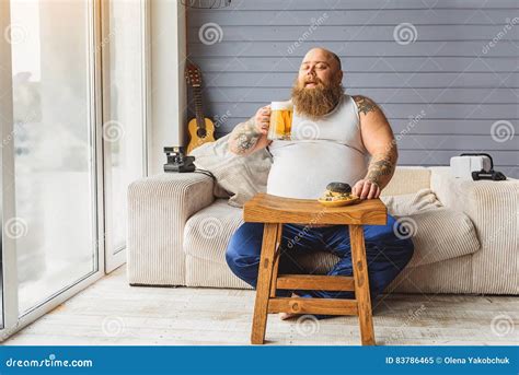 Fat Guy Relaxing With Alcohol Drink Stock Image Image Of Junk Couch