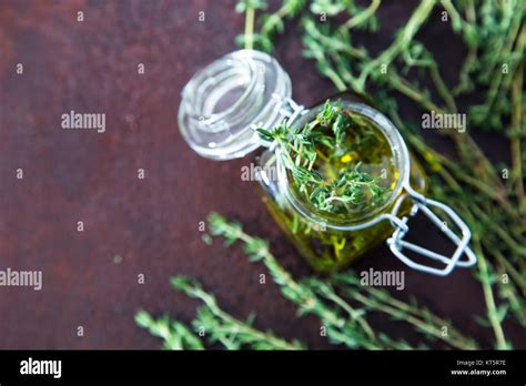 Thyme Oil Thyme Essential Oil Jar Glass Bottle And Branches Of Plant