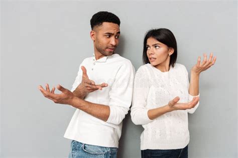 Confused Loving Couple Gesturing With Hands Stock Image Image Of