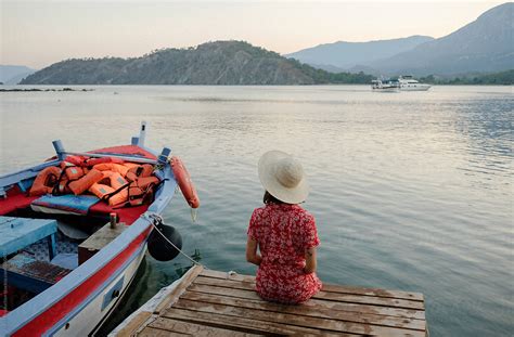 Woman Relaxing On The Boat Pier By Stocksy Contributor EASY 2 SHOOT