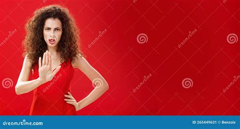 Hold On Stop Intense Serious Looking Displeased Adult Woman With Curly Hair In Stylish Red