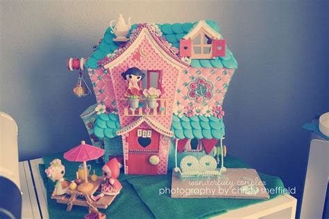 a doll house on top of a dresser