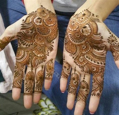 Two Hands With Henna Designs On Them