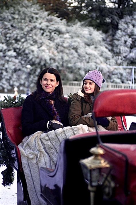 Two Women Sitting In The Back Of A Red Truck On Snow Covered Ground