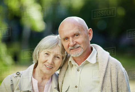 Portrait Of Cute Senior Couple Standing Together Outside Stock Photo