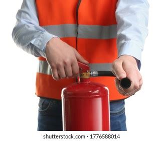 Worker Using Fire Extinguisher On White Stock Photo