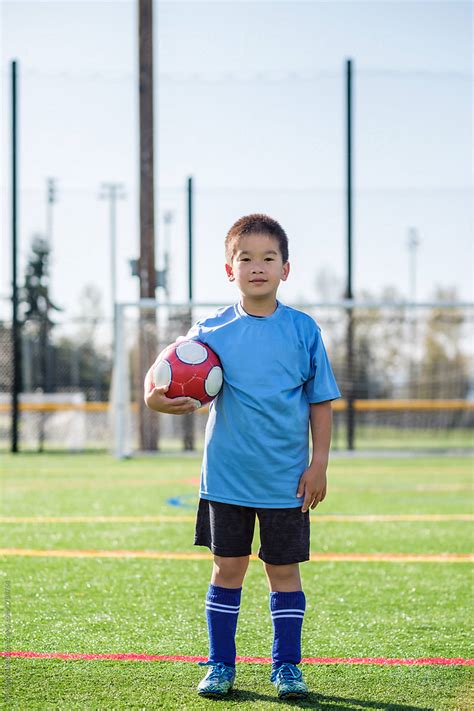 "Happy Asian Boy Holding A Soccer Ball" by Stocksy Contributor "Take A ...