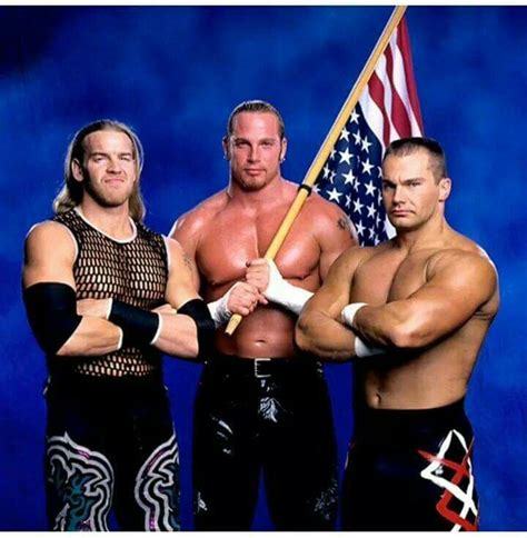 Two Men Standing Next To Each Other Holding A Flag And An American Flag On Top Of Their Shoulders