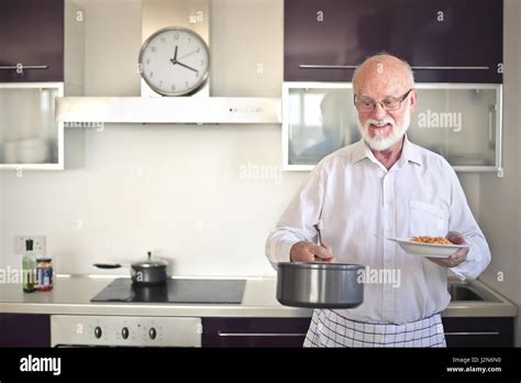 Old Man Cooking In Home Stock Photo Alamy