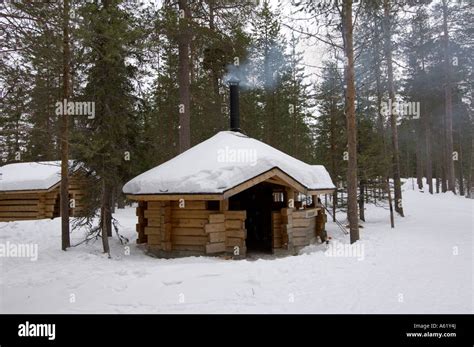 Typical Finnish Log Cabin In The Forest In The Snow Luosto Lapland