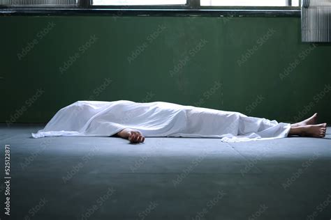 Dead Woman Lying Down Under White Cloth Covered Death Body From Murder At House Of Victim Stock