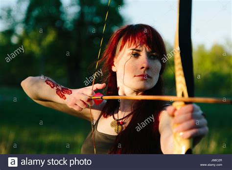 Female Archer Shooting Bow Arrow Stock Photos And Female Archer Shooting