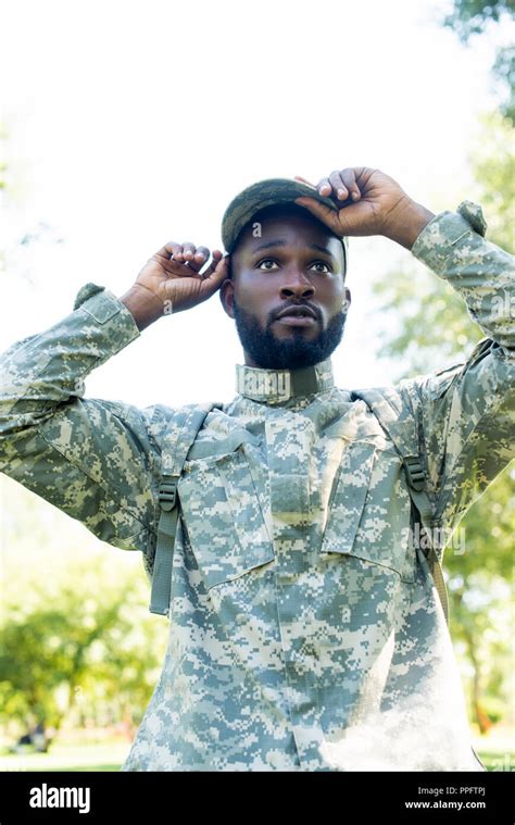 handsome african american soldier in military uniform wearing cap in park Stock Photo - Alamy