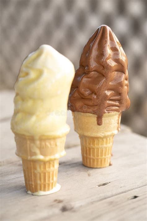 A Vanilla And Chocolate Ice Cream Cone Melting In The Summer Heat Stock